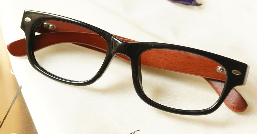 Cenny Eyeglasses - Black placed on the table