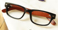 Cenny Eyeglasses - Black placed on the table
