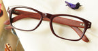 Uniek Eyeglasses - Brown placed on the table