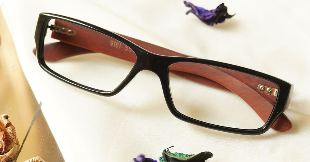 Unico Eyeglasses - Black placed on the table