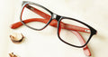 Superieur Eyeglasses - Brown placed on the table
