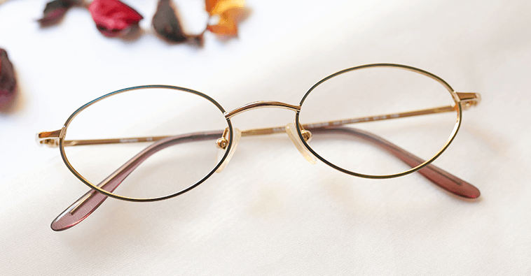 Assiduous Eyeglasses - Golden placed on the table