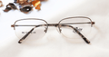 Dandelion Eyeglasses - Silver placed on the table