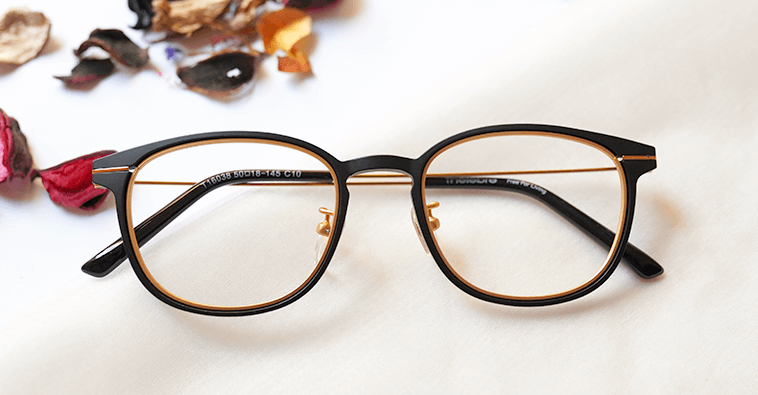 Neon Eyeglasses - Black & Golden colored, placed on the table