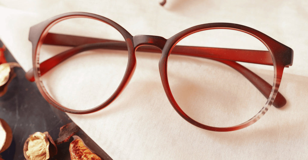 Stea Eyeglasses mahroon colored placed on the table