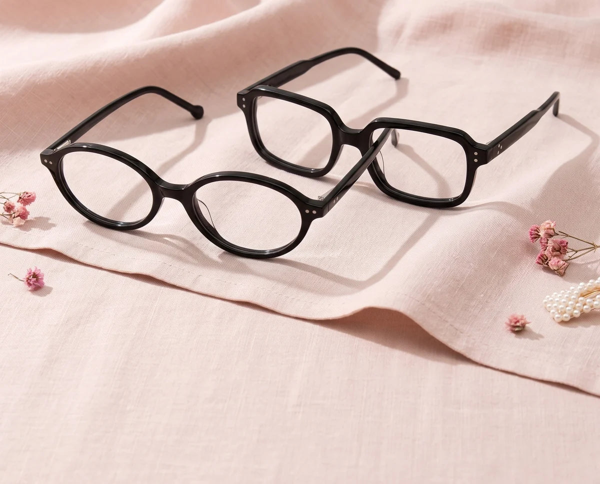 Soft Retro. Black oval and rectangle glasses on blush linen.