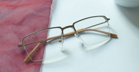 Bom rimless metal eyeglasses placed on the white table
