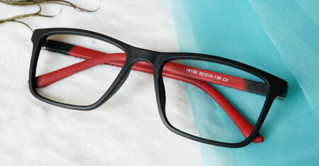 Black and Red Glasses placed on blue and white fabric