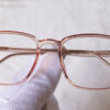 Mojosa light brown square shaped full frame eyeglasses in someone's hand