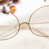 Belly Eyeglasses - Golden placed on the table