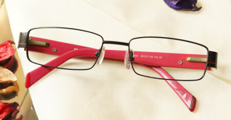 Overlegen Eyeglasses - Pink placed on the table