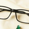 Exquisite Eyeglasses - Black placed on the table