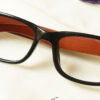 Cenny Eyeglasses - Black placed on the table