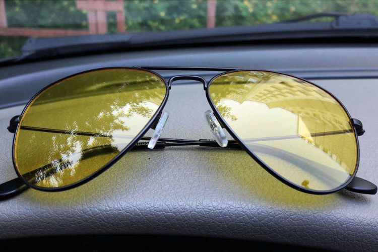 Driving glasses placed on car dashboard